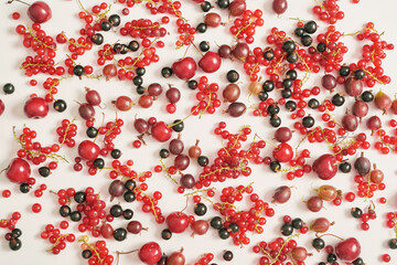 Fruit pattern of colorful fresh berries on white background. Top view. Flat lay. Summer Organic Berry Cherry, Currant, Gooseberry. Agriculture, Gardening, Harvest Concept. Vitamins, Healthy Diet.