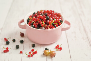 Colorful fresh berries on white background. Top view. Summer Organic Berry Cherry, Currant, Gooseberry. Agriculture, Gardening, Harvest Concept. Vitamins, Diet. Copy space. Healthly food, detox