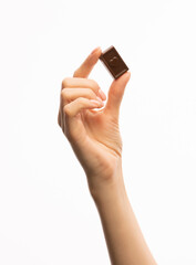 
Female hand with candy on a white background
