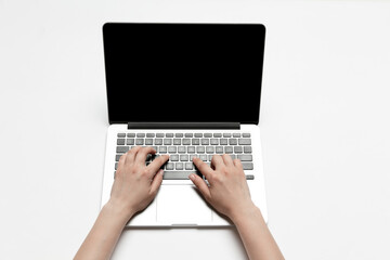 Close up of human hands using laptop isolated on white background. Top view. Copyspace, blank screen. Surfing, online shopping, scrolling, betting, working. Education and business concept.