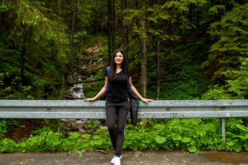 Girl travels to the mountains. Hiking. High mountains in summer on a rainy day. Тatras.