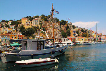 Symi town, Symi island, a boat in Yialos harbour, Symi island, Greece