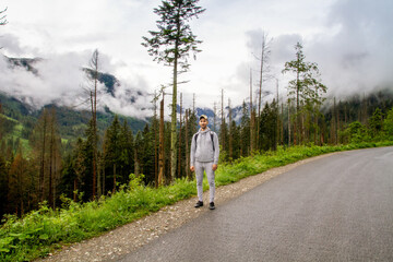 Obraz premium A man travels to the mountains. Hiking. High mountains in summer on a rainy day. Тatras.