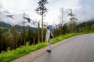 Obraz premium A man travels to the mountains. Hiking. High mountains in summer on a rainy day. Тatras.