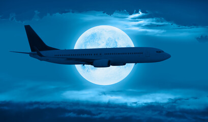 Fototapeta na wymiar Passenger airplane in the sky on the background full moon at sunset 
