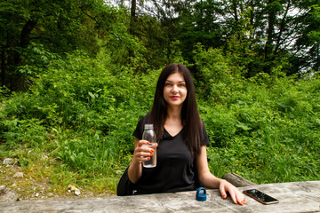 Girl travels to the mountains. Hiking. High mountains in summer on a rainy day. Тatras.