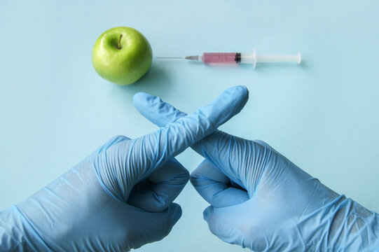 The Sign Of The Cross Of Fingers, As A Sign Of Protest GMO With Vegetables And Fruits.