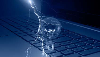 Light bulb on keyboard laptop with lightning