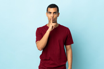 African American man over isolated background showing a sign of silence gesture putting finger in mouth