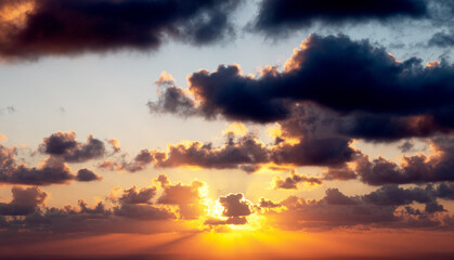 Sunset on a background of dark clouds