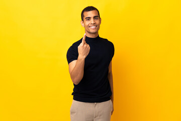 Fototapeta premium African American man over isolated background doing coming gesture