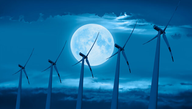 Wind turbines generating electricity with amazing cloudy sky - Night sky with moon in the clouds "Elements of this image furnished by NASA 