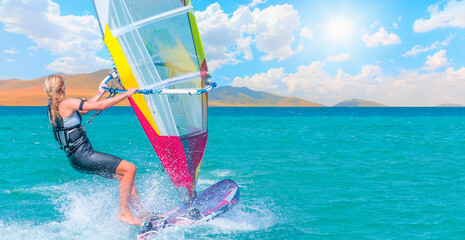 Beautiful cloudy sky with Windsurfer Surfing The Wind On Waves In Alacati - Cesme, Turkey 