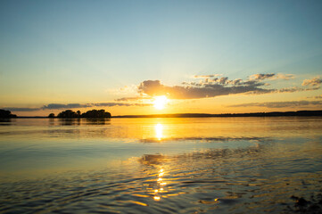 Fototapeta na wymiar Magical fairytale sunset in the evening on the lake