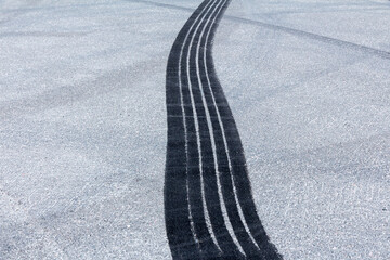 black rubber tyre skid marks on tarmac road