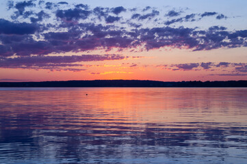 Fototapeta na wymiar Magical fairytale sunset in the evening on the lake