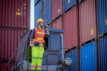 A dock worker under discussion about dock container shipping warehouse working, he wearing safety...