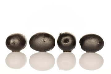 Pickled spicy black olives, close-up, on a white background.