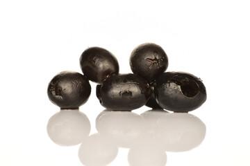 Pickled spicy black olives, close-up, on a white background.