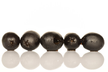 Pickled spicy black olives, close-up, on a white background.