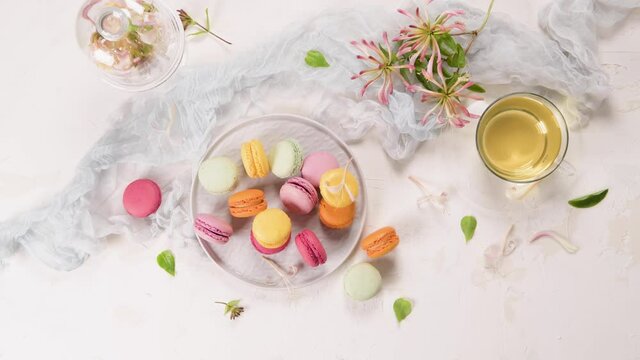 A french sweet delicacy, macaroons variety closeup. Color fresh macaroons on wooden background.
