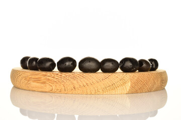 Pickled spicy black olives, close-up, on a white background.