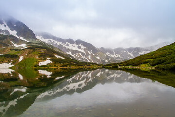 Naklejka na ściany i meble Mountains lakes. Valley of the five ponds in the Tatras. Rainy day. Shooting with raindrops.