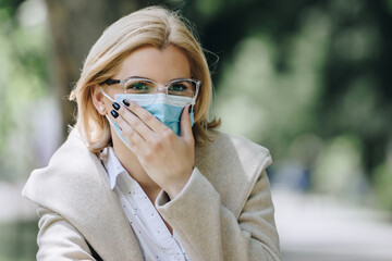 woman wearing medical face mask outside
