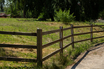 Fototapeta na wymiar old wooden fence in the meadow