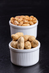 Dried peanuts on black stone background