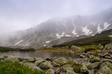 Mountains lakes. Valley of the five ponds in the Tatras. Rainy day. Shooting with raindrops.