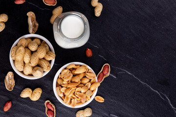 Dried peanuts on black stone background