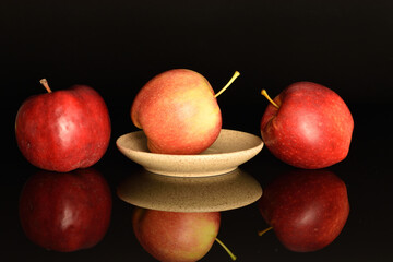 Red ripe apples, close-up, on a black background.