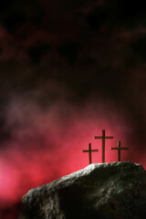Three crosses against red sky on Calvary hill background. Crucifixion, resurrection of Jesus...