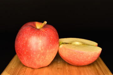 Red ripe apples, close-up, on a black background.