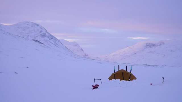 A tranquil dawn at a winter campsite in Sarek, Swedish Lapland.