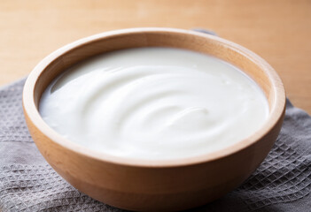 Yogurt on a wooden background