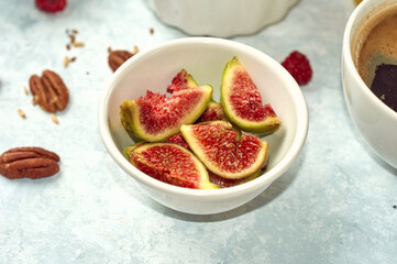 fresh purple figs in a white bowl on the table