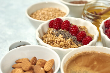 Steel cut oatmeal porridge with raspberry and nuts for breakfast
