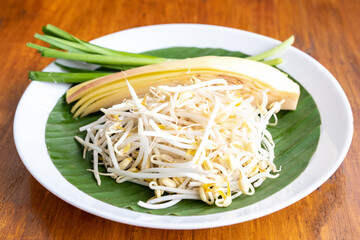 Fresh banana blossom with spring and onion sprouts