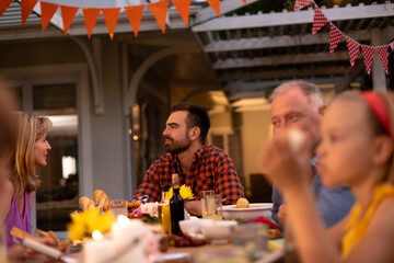 Happy Caucasian family eating together at table