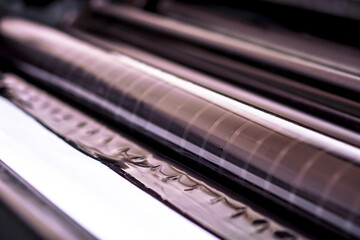 Traditional offset press. Printing in ink with CMYK, cyan, magenta, yellow and black. Graphic arts,...