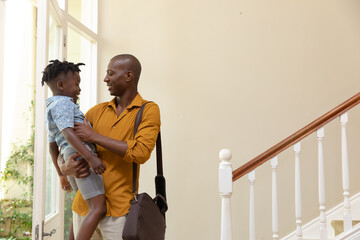 African American man arriving home with his young son