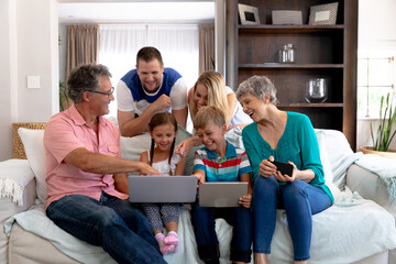 Portrait of a three generation Caucasian family  sitting on a couch at home