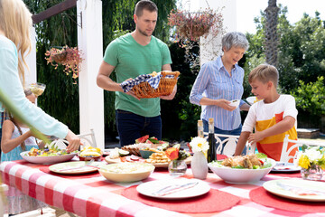Caucasian three generation family preparing a lunch in the garden 