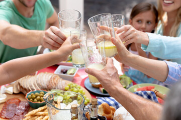 Caucasian family sitting at table during a family lunch in the garden