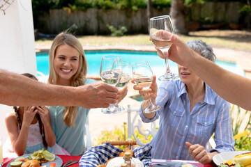Caucasian family sitting at table during a family lunch in the garden