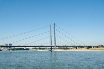 Fototapeta na wymiar Dusseldorf, Germany – July 24, 2019: The Rheinkniebrücke is a cable-stayed bridge over the Rhine in Düsseldorf, opened to traffic on 16 October 1969.