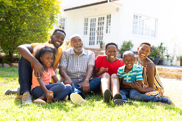 Fototapeta premium Three generation African American family spending time together in their garden. 