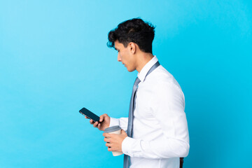 Young Argentinian businessman over isolated blue background